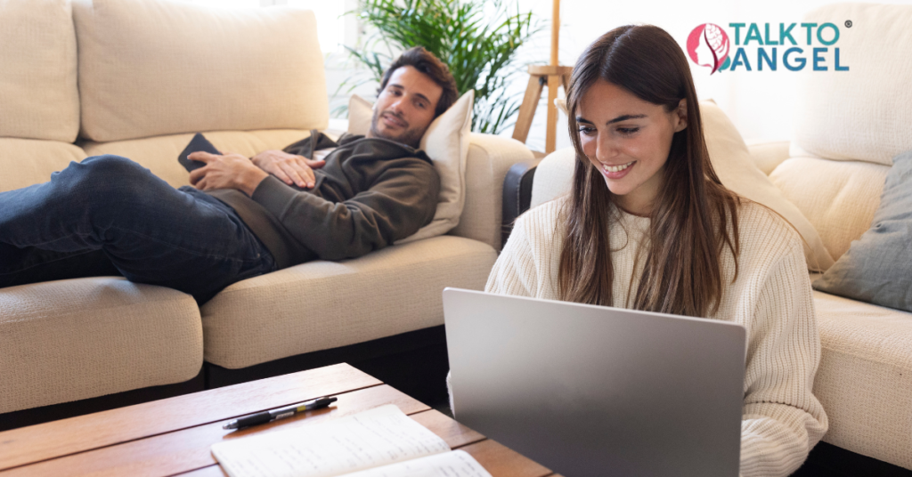 Busy couple attending online therapy session on laptop at home