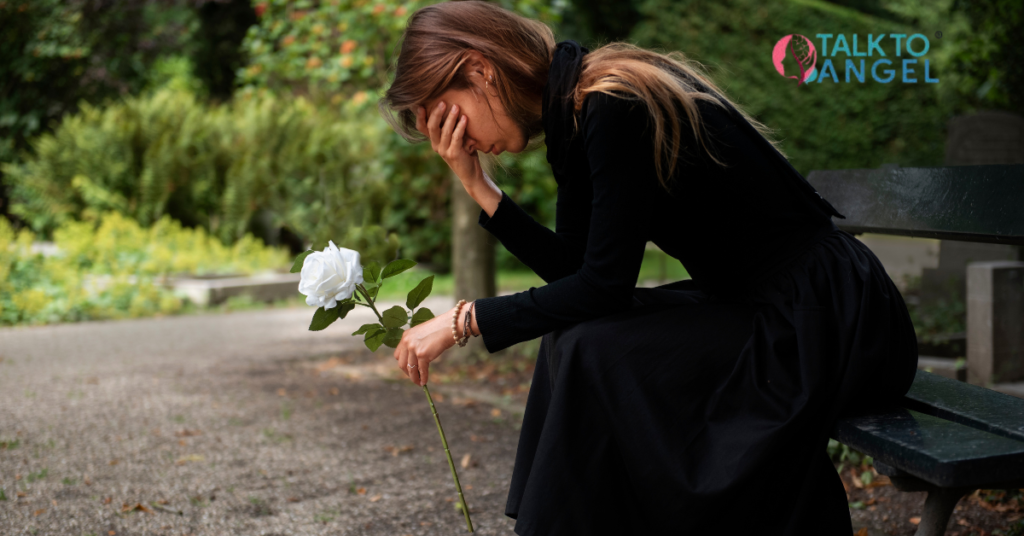 Person sitting alone feeling sad after loss, representing grief & depression