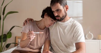 Couple sitting apart looking stressed due to infertility struggles