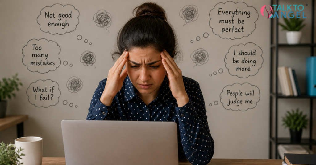 Person feeling stressed while working on laptop, struggling with perfectionism and OCD