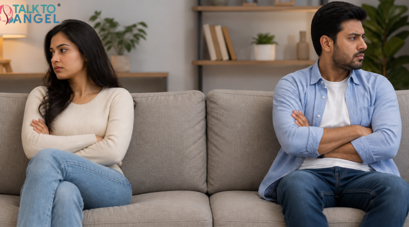 Couple sitting apart on sofa, showing emotional distance & lack of intimacy in relationship
