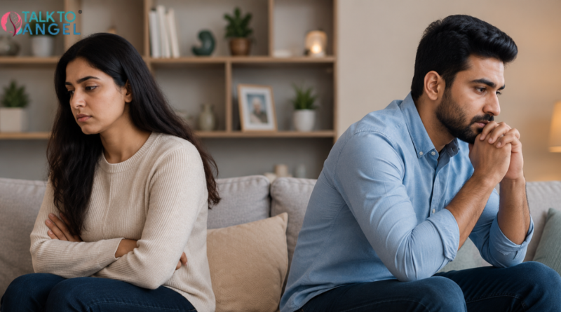 Couple sitting apart looking tense, reflecting emotional distance, communication issues, & the need for couples therapy
