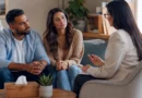 Couple discussing relationship problems with a counsellor for professional support and guidance.