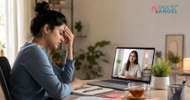 Person experiencing a stress headache while receiving online counselling support through a virtual therapy session.